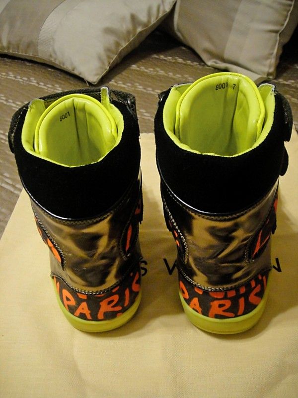 They feature a black upper with the name written in graffiti print, as 